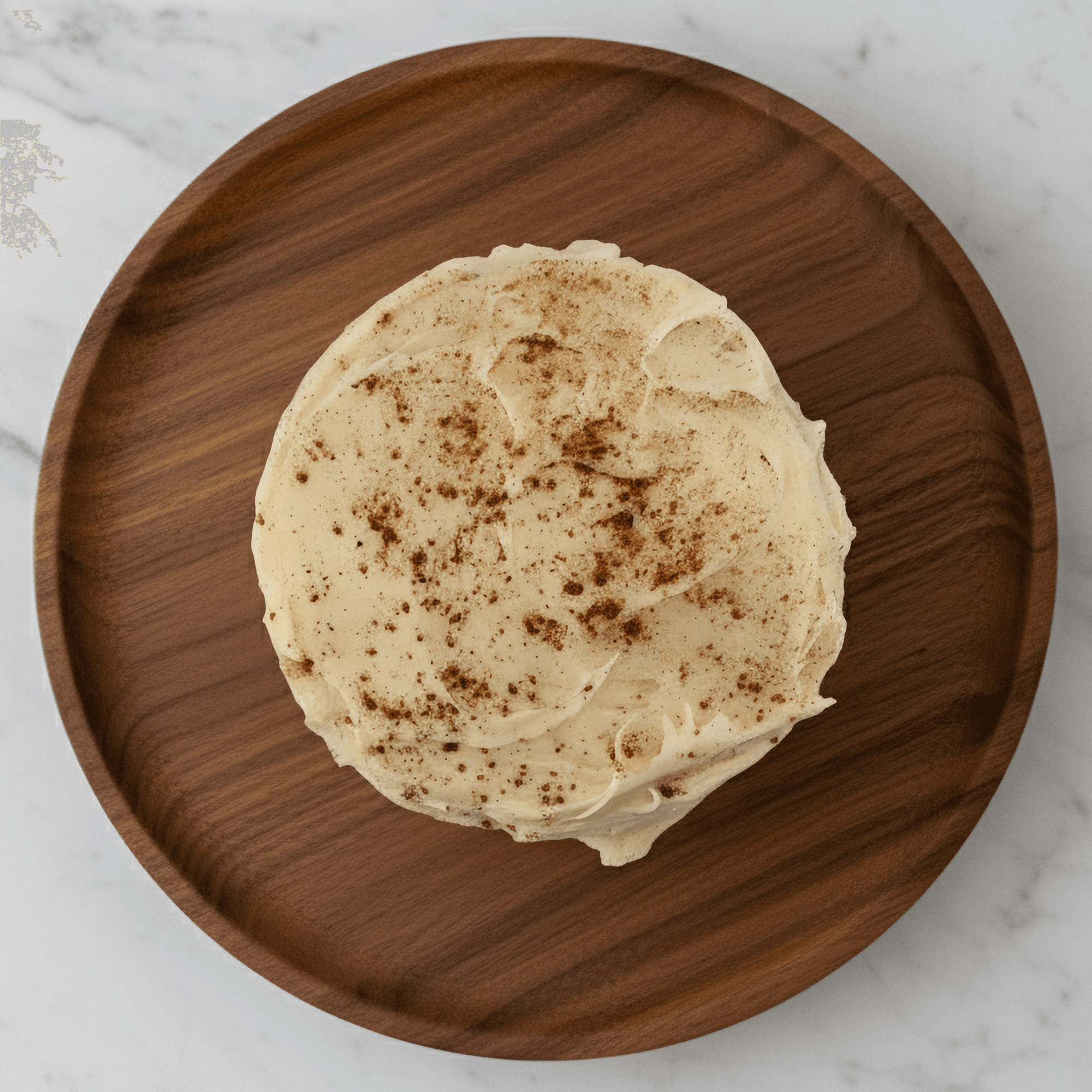 Delicious Pumpkin Spice Protein Cake Mix with creamy frosting on a wooden plate. Perfect healthy dessert for fall!