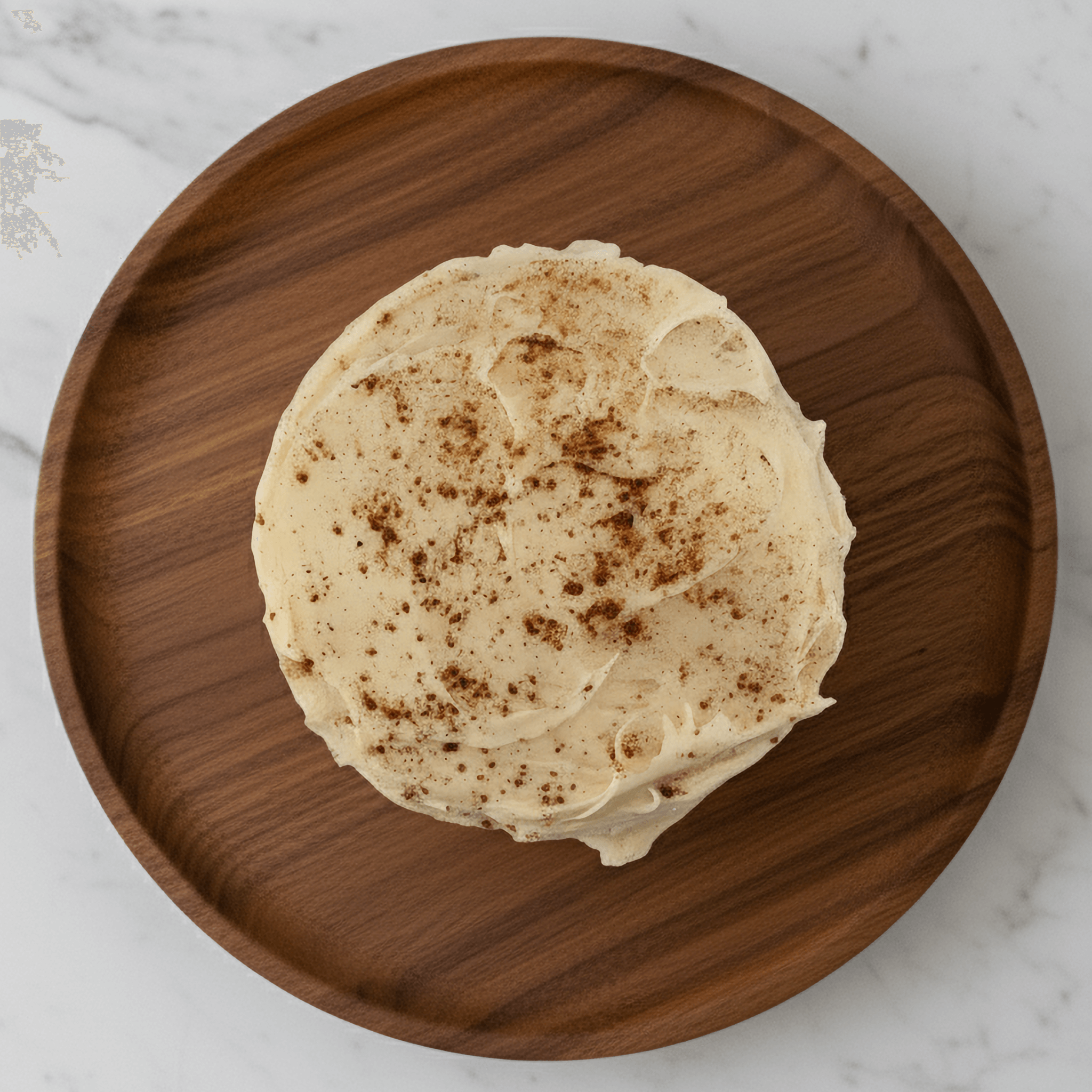 Delicious Pumpkin Spice Protein Cake Mix with creamy frosting on a wooden plate. Perfect healthy dessert for fall!