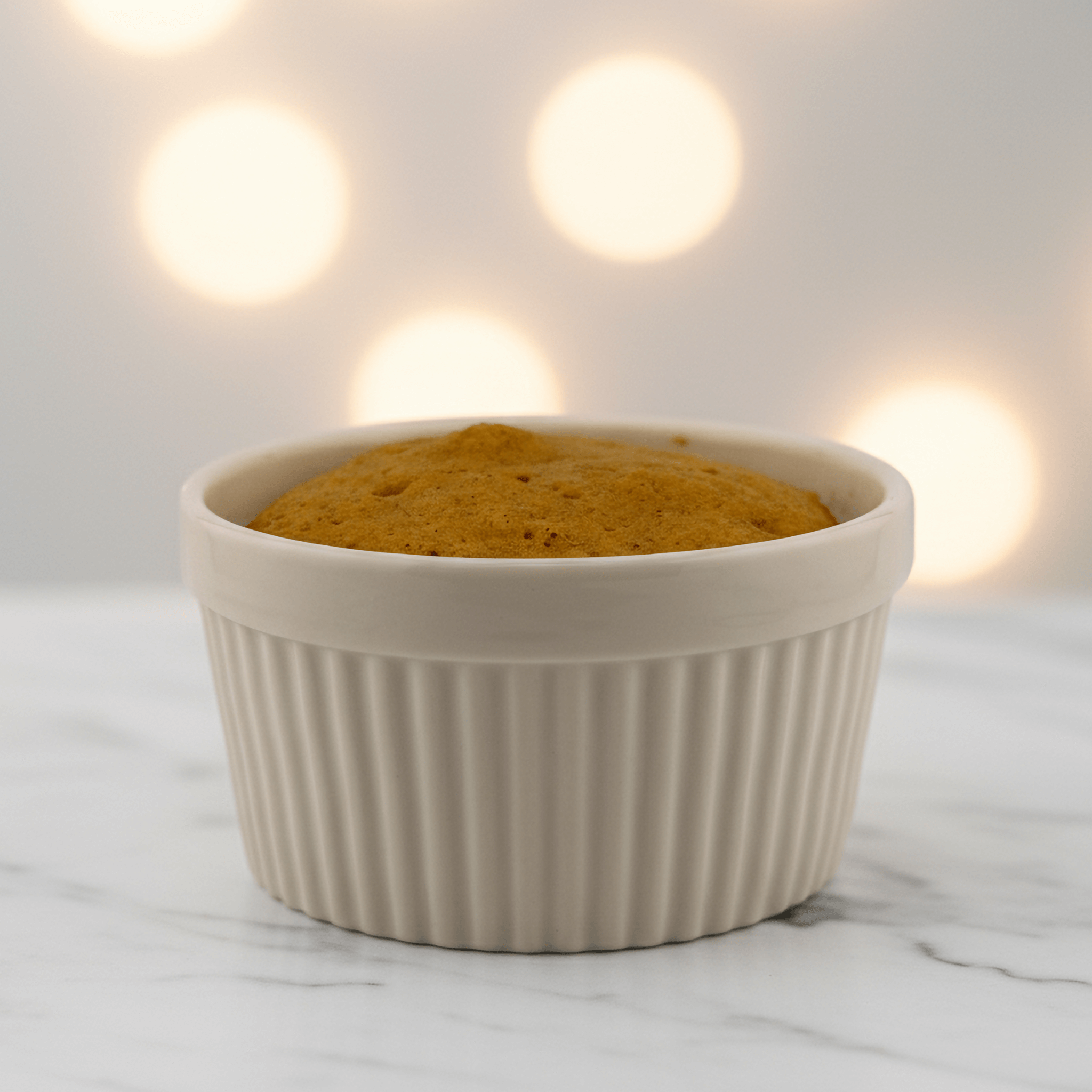 Pumpkin Spice Protein Cake Mix in a white ramekin, a healthy dessert with warm autumn flavors, microwaveable and protein-packed.