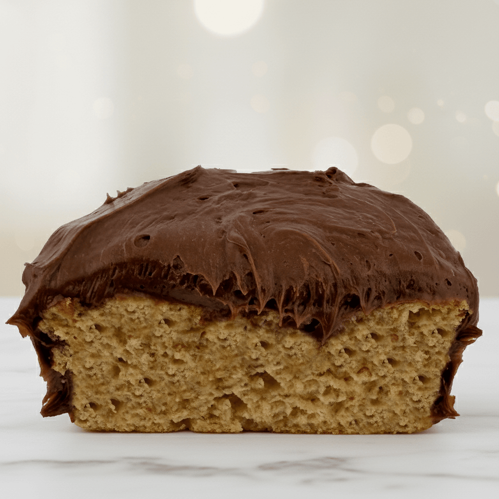 Vanilla Protein Cake Mix with chocolate frosting, showcasing a healthy dessert option for protein lovers.