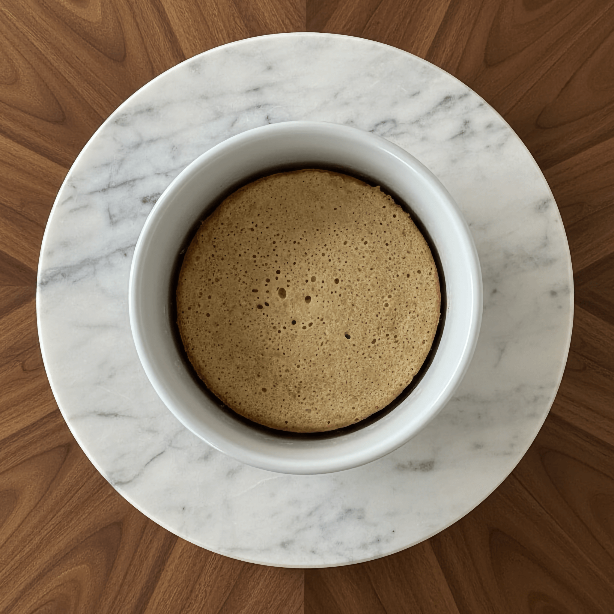 Vanilla Protein Cake Mix baked in a bowl on a marble counter, showcasing a moist protein cake dessert.